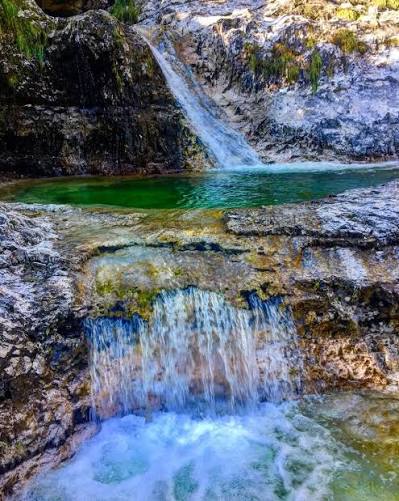 Vasca naturale smeraldo dei Cadini del Brenton con piccola cascata, Valle del Mis, Dolomiti Bellunesi